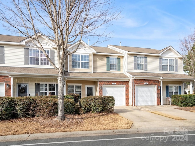 multi unit property featuring a garage