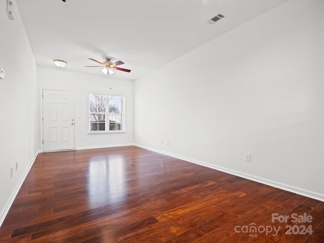 unfurnished room with ceiling fan and dark hardwood / wood-style flooring