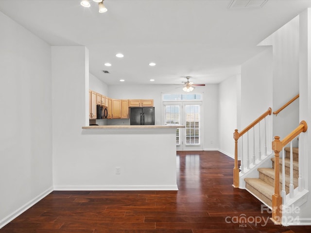 kitchen featuring kitchen peninsula, light brown cabinetry, ceiling fan, dark wood-type flooring, and black appliances