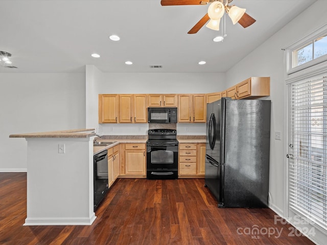 kitchen featuring light brown cabinetry, dark hardwood / wood-style flooring, and black appliances