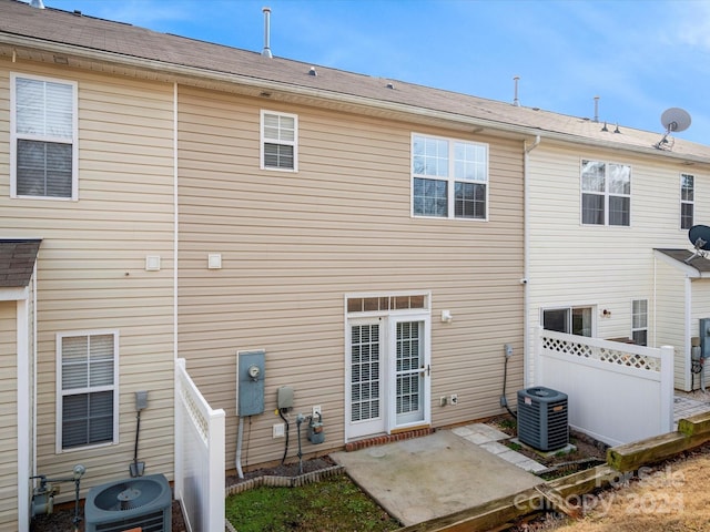 rear view of house featuring central AC unit and a patio