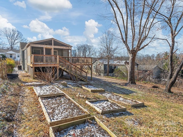 view of yard featuring a sunroom and a deck