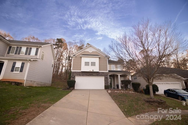 view of property with a garage and a yard