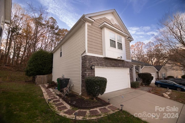 property exterior at dusk featuring a garage