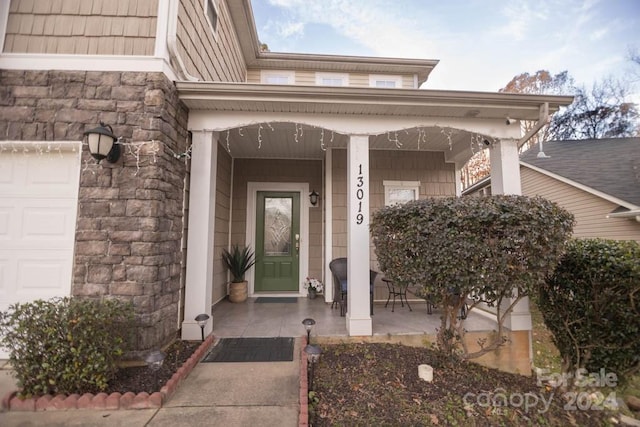 property entrance featuring covered porch