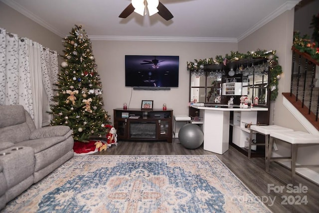 living room with ceiling fan, ornamental molding, and dark wood-type flooring