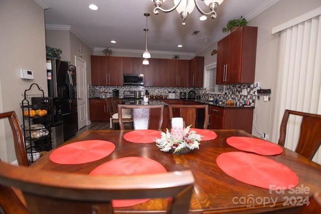 dining area with ornamental molding and an inviting chandelier