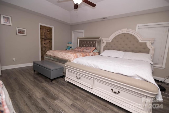 bedroom with connected bathroom, ceiling fan, and dark hardwood / wood-style floors