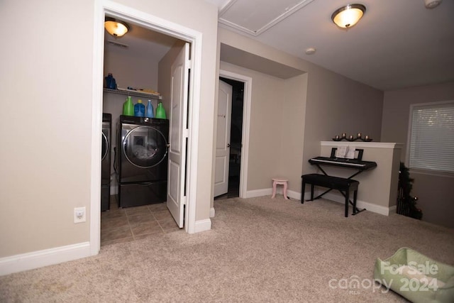 clothes washing area featuring light carpet and washer and clothes dryer