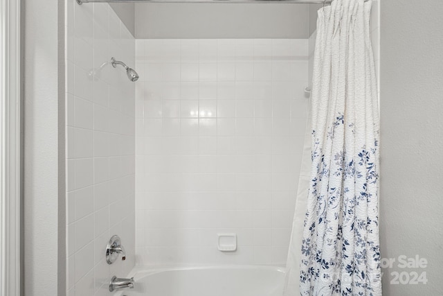 bathroom with shower / bathtub combination with curtain