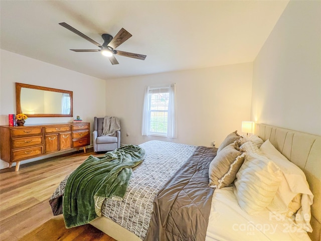 bedroom with a ceiling fan and wood finished floors
