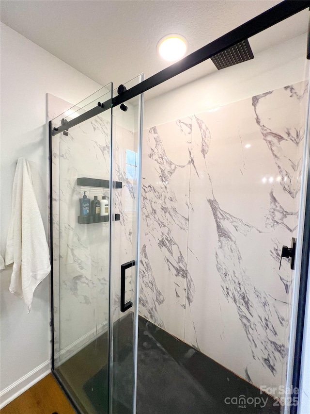 full bath featuring a marble finish shower