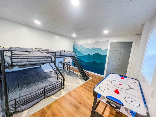 bedroom with recessed lighting and wood finished floors