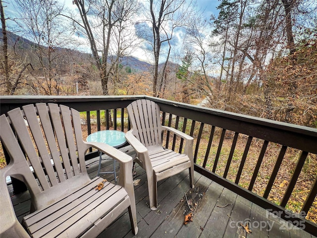wooden deck with a mountain view