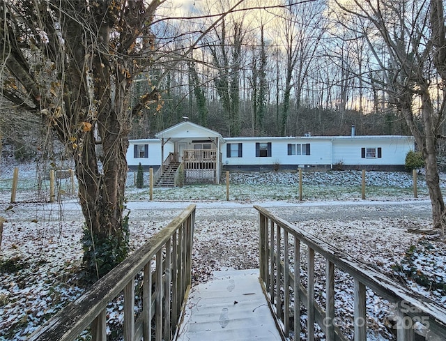 view of snow covered back of property