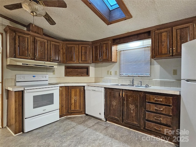 kitchen with sink, white appliances, dark brown cabinets, a textured ceiling, and ceiling fan