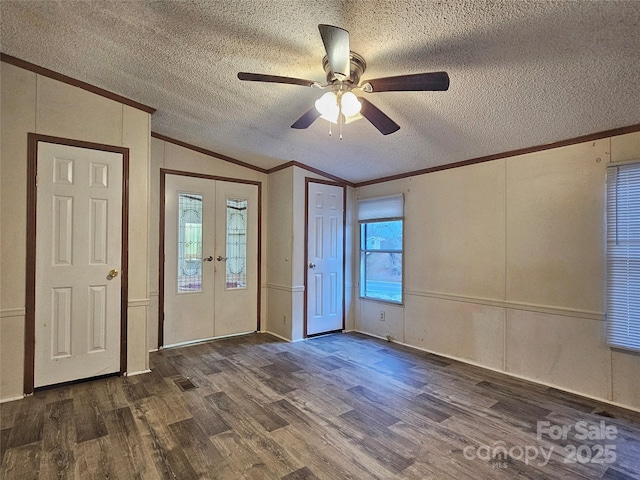 entryway featuring french doors, ornamental molding, lofted ceiling, and dark hardwood / wood-style floors