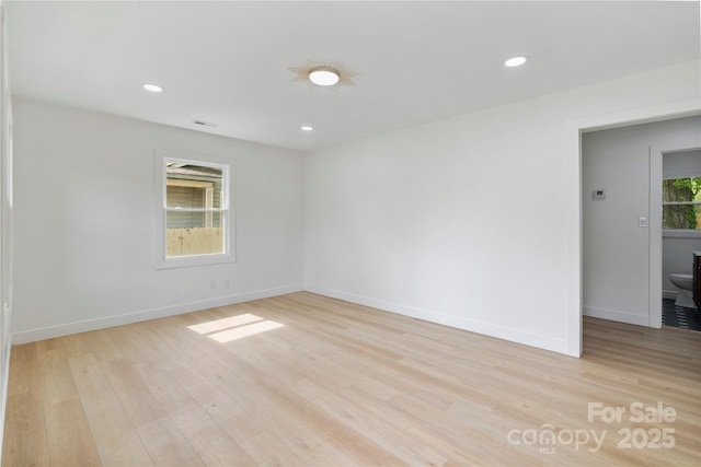 unfurnished room featuring light wood-style floors, baseboards, and recessed lighting