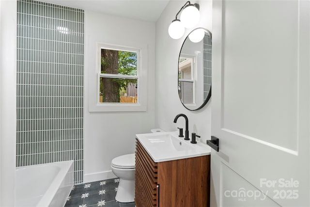 full bath featuring toilet, vanity, and baseboards