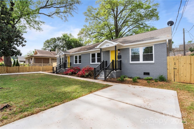 ranch-style house featuring brick siding, a front lawn, fence, and crawl space