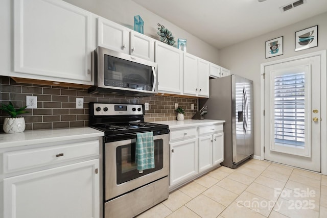 kitchen featuring visible vents, white cabinets, decorative backsplash, stainless steel appliances, and light countertops