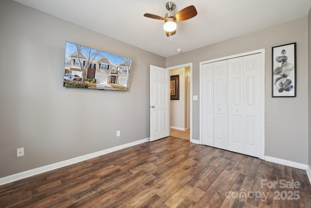 unfurnished bedroom with a closet, ceiling fan, baseboards, and wood finished floors