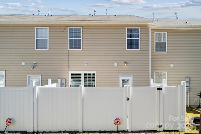 back of house with fence