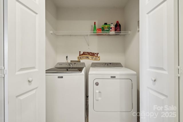 clothes washing area featuring laundry area and washing machine and dryer