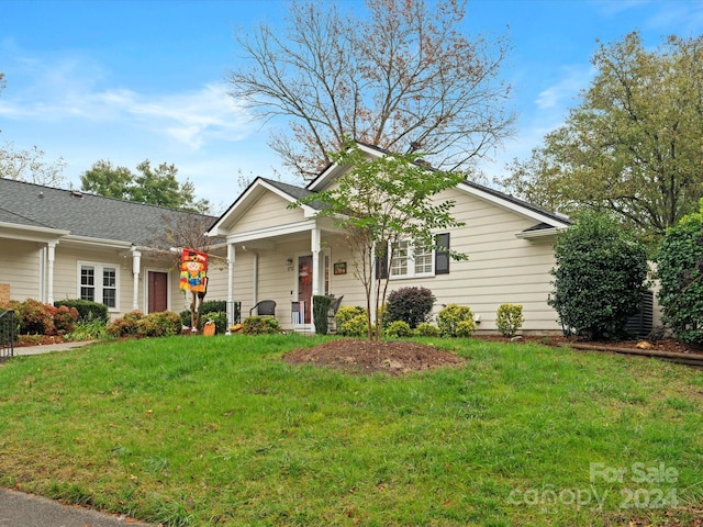 view of front of property with covered porch and a front yard