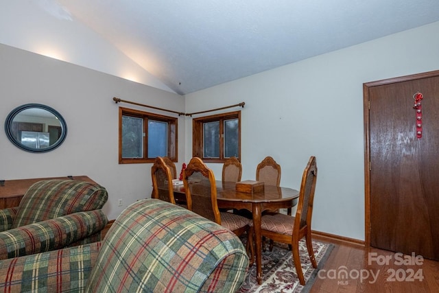 dining room with lofted ceiling and hardwood / wood-style flooring