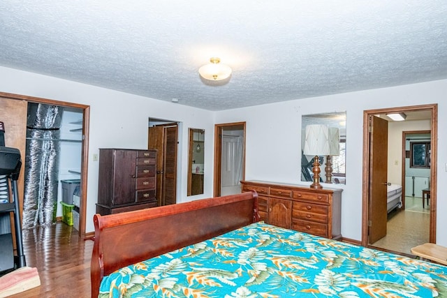 bedroom featuring wood-type flooring and a textured ceiling