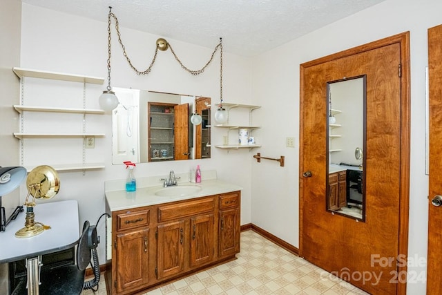 bathroom with vanity and a textured ceiling