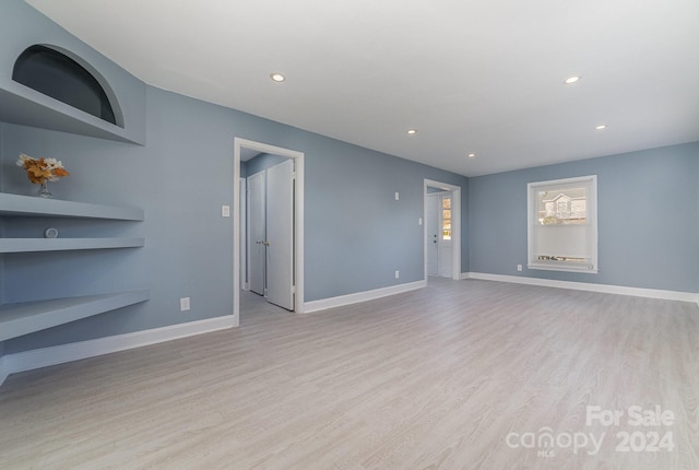 unfurnished living room with light wood-type flooring