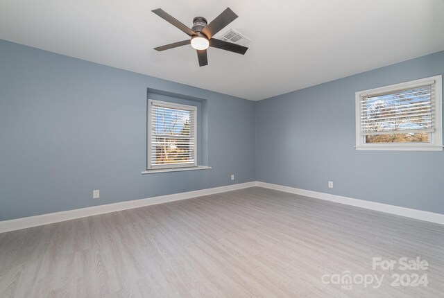 empty room featuring ceiling fan and light hardwood / wood-style flooring