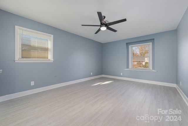 empty room featuring ceiling fan and light hardwood / wood-style flooring