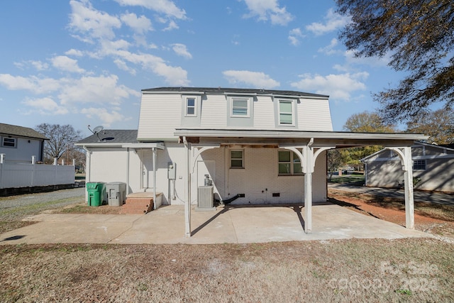 rear view of house featuring cooling unit and a patio area