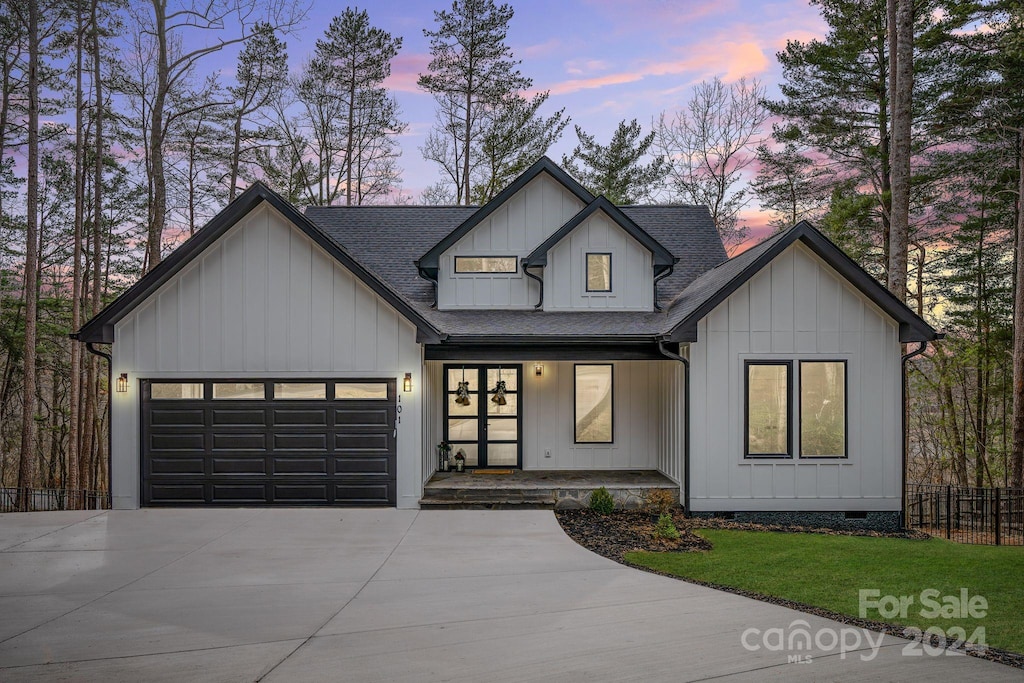 modern inspired farmhouse with covered porch and a garage