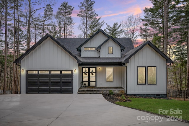 modern inspired farmhouse with covered porch and a garage