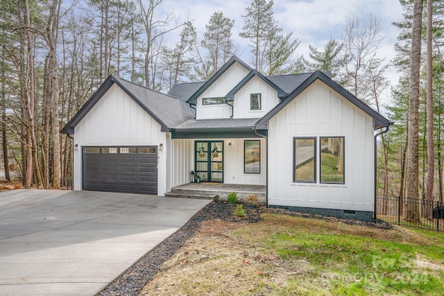 modern farmhouse style home featuring a porch and a garage