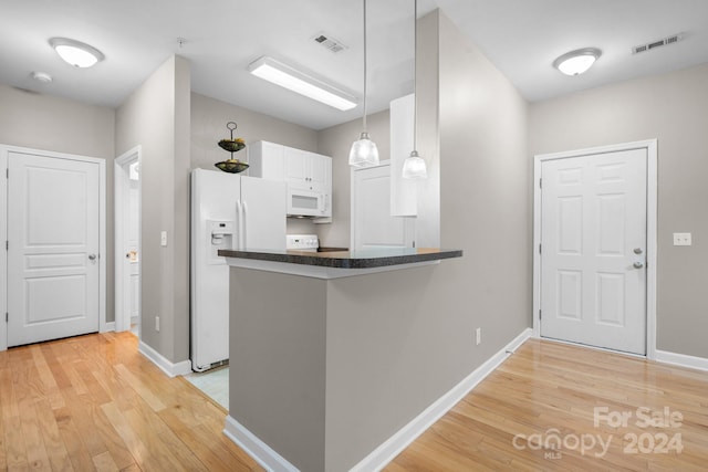 kitchen featuring hanging light fixtures, kitchen peninsula, light hardwood / wood-style floors, white appliances, and white cabinets