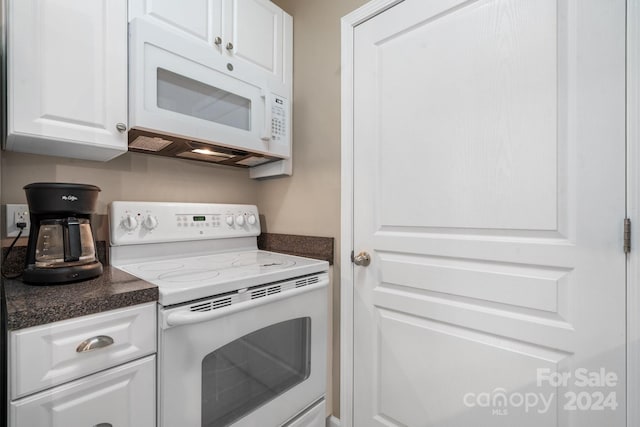 kitchen with white appliances and white cabinetry