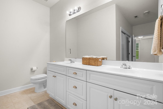 bathroom featuring tile patterned floors, vanity, and toilet