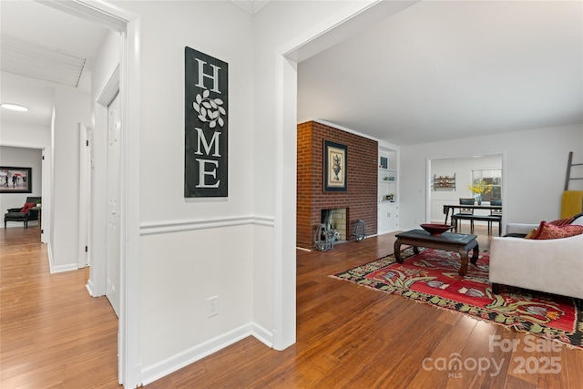 hallway with wood-type flooring and built in features