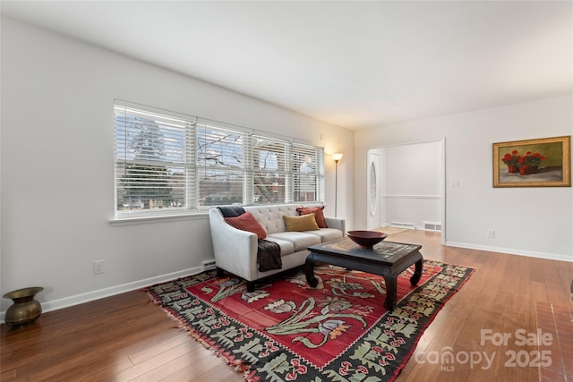 living room featuring baseboard heating and wood-type flooring