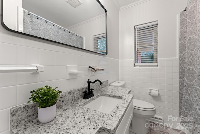 bathroom with ornamental molding, tile walls, vanity, and toilet