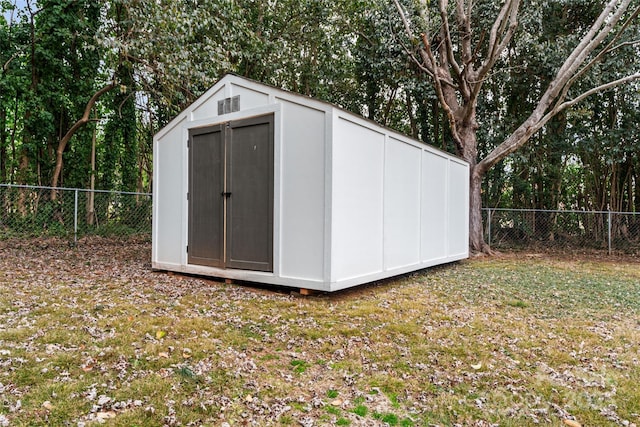 view of outbuilding with a lawn