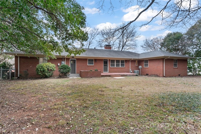 back of property featuring a lawn