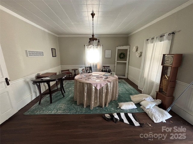 dining space featuring ornamental molding and dark hardwood / wood-style floors