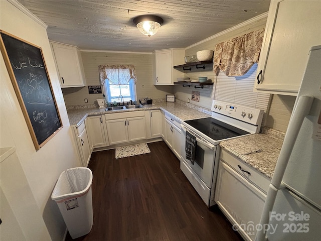 kitchen featuring sink, electric stove, and white cabinetry