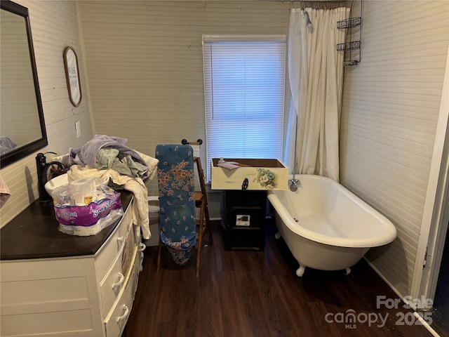 bathroom with wood-type flooring and a tub